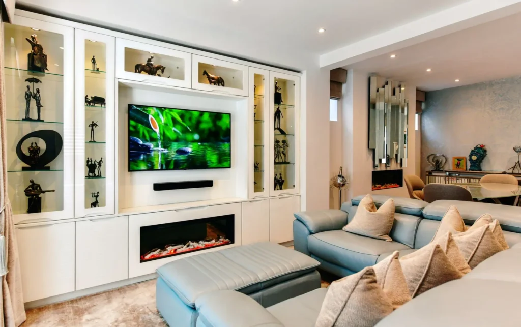 Bespoke media wall in a modern UK living room with built-in TV and shelving