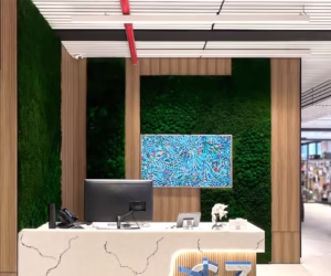 Sustainable living green wall media backdrop with organic moss and wooden branding.